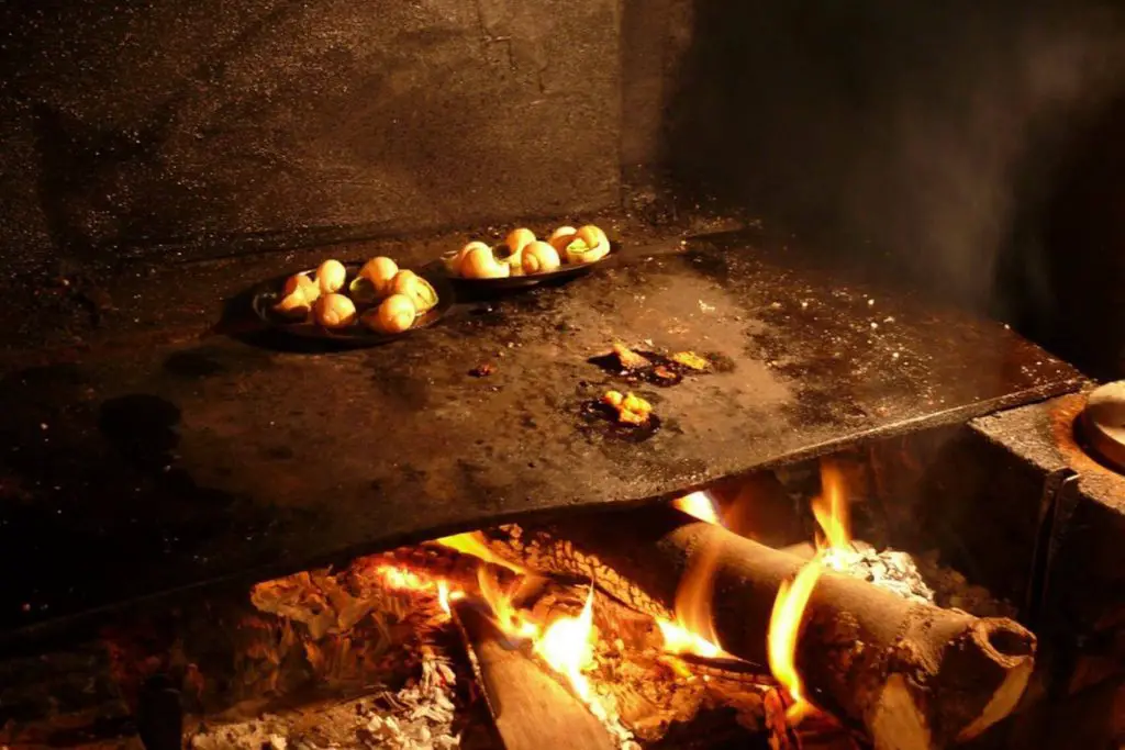 Escargot cooking over an open flame at Robert et Louise, one of the best places to eat escargot in Paris